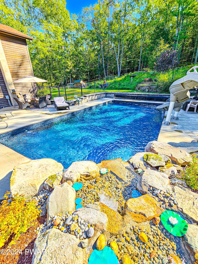 view of swimming pool with a patio area