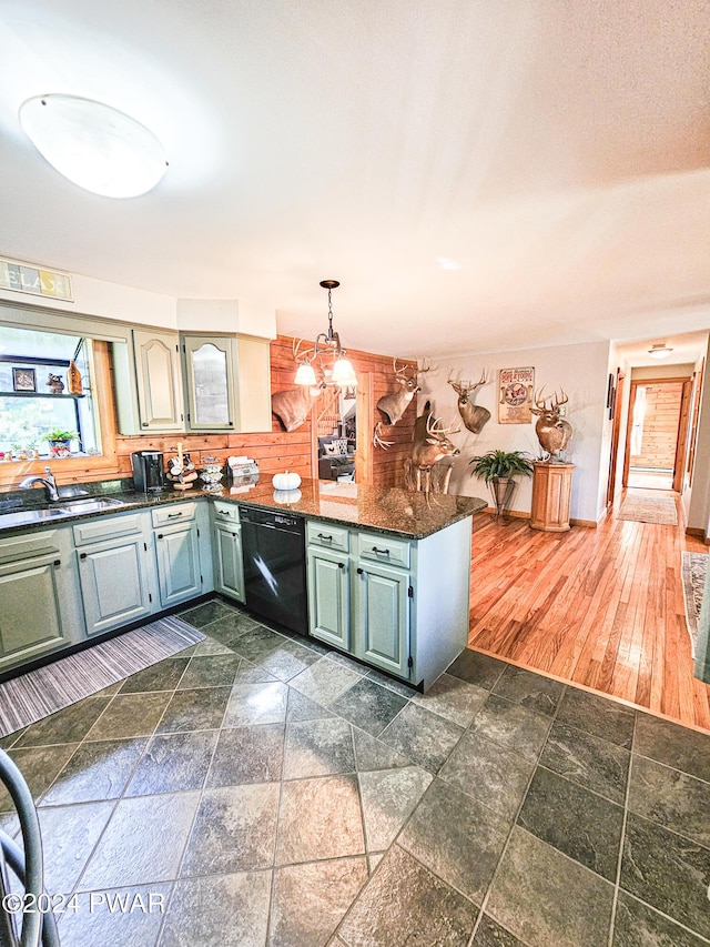 kitchen with sink, kitchen peninsula, black dishwasher, and hanging light fixtures