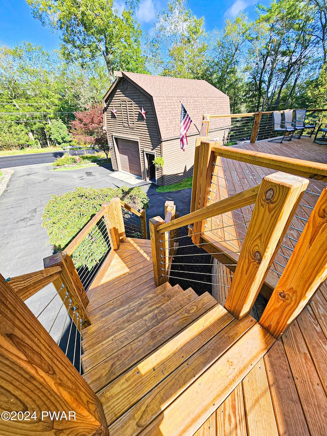 wooden deck featuring a garage