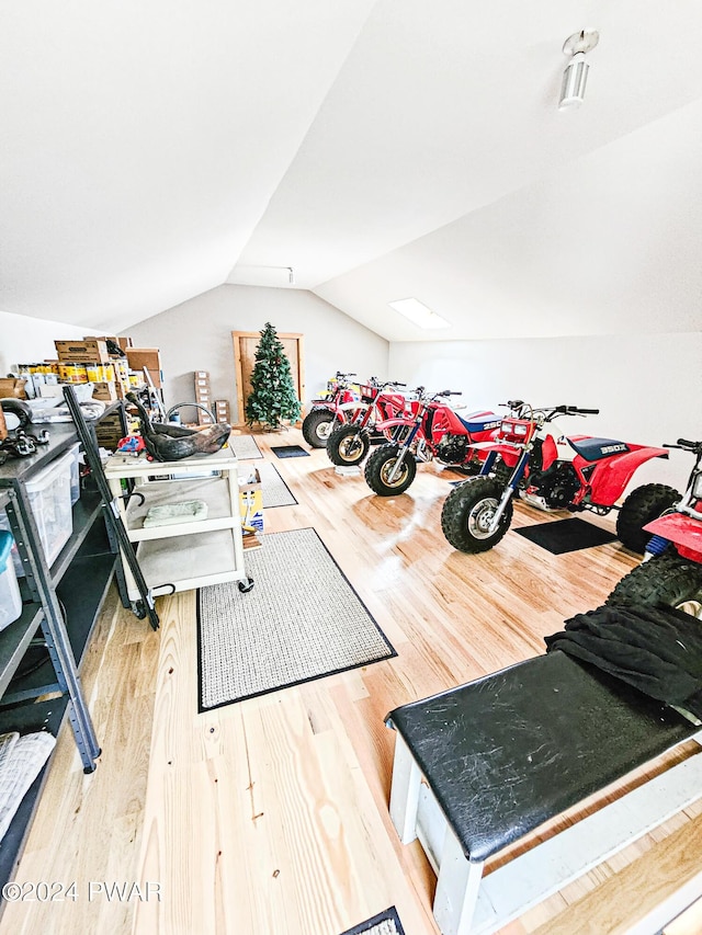 miscellaneous room with hardwood / wood-style floors and lofted ceiling