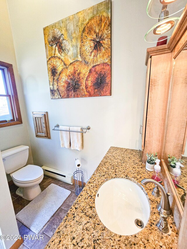 bathroom featuring vanity, a baseboard radiator, and toilet