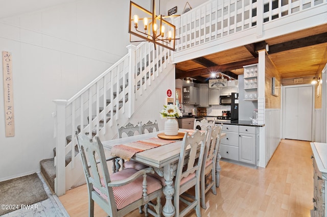 dining room featuring wooden ceiling, light hardwood / wood-style flooring, and a chandelier