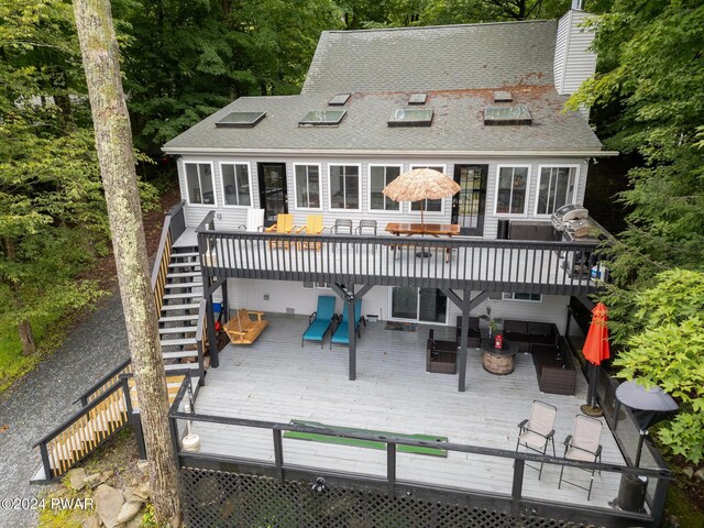 back of house with outdoor lounge area and a wooden deck