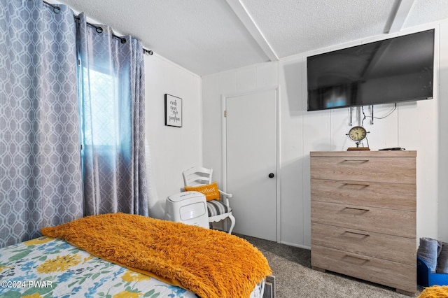 carpeted bedroom featuring a textured ceiling