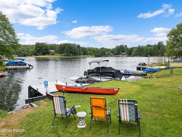 dock area featuring a lawn and a water view