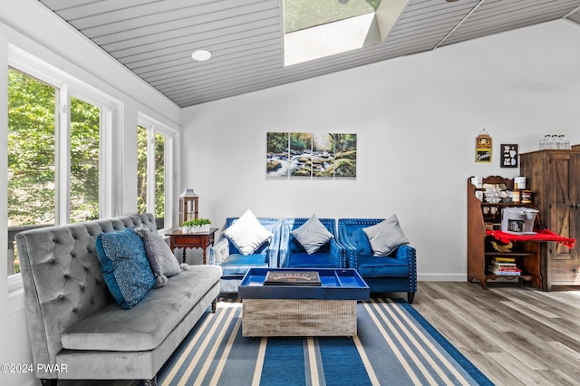 living room featuring hardwood / wood-style floors and vaulted ceiling