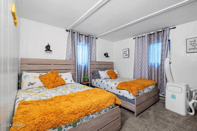 carpeted bedroom with a textured ceiling