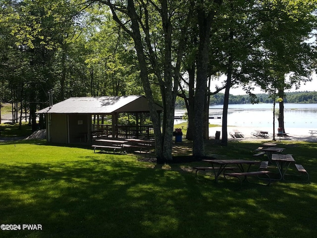 view of home's community featuring a gazebo, a water view, and a lawn