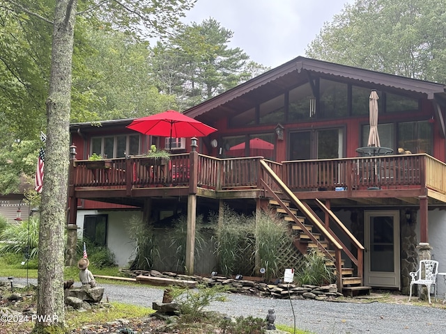 back of house featuring a wooden deck