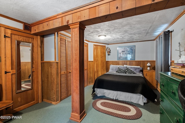 carpeted bedroom with a textured ceiling, crown molding, and wooden walls