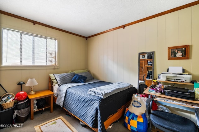 bedroom with a textured ceiling, ornamental molding, and carpet flooring