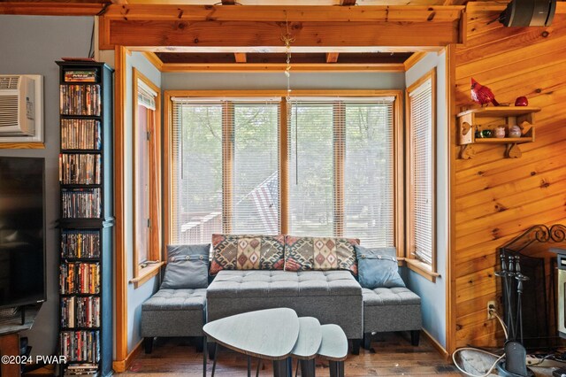 living room featuring vaulted ceiling with beams, wooden walls, hardwood / wood-style floors, and wooden ceiling