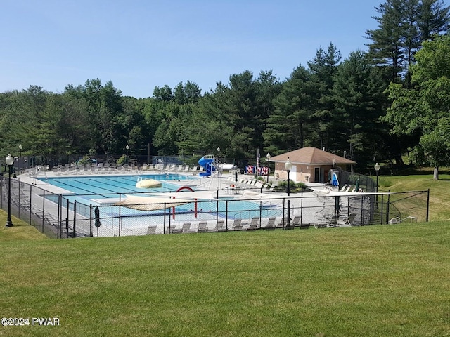 view of pool with a patio area and a yard