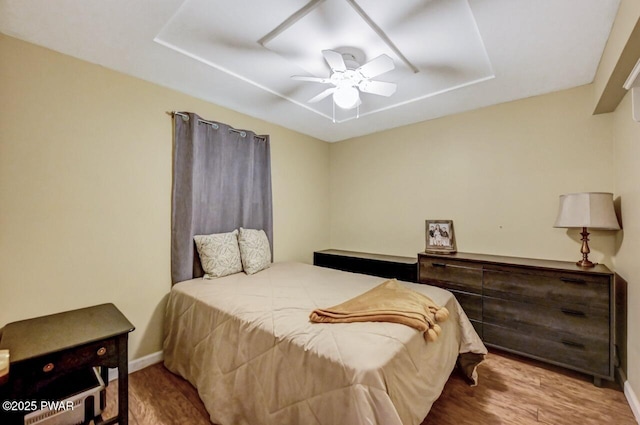 bedroom with ceiling fan and light hardwood / wood-style floors