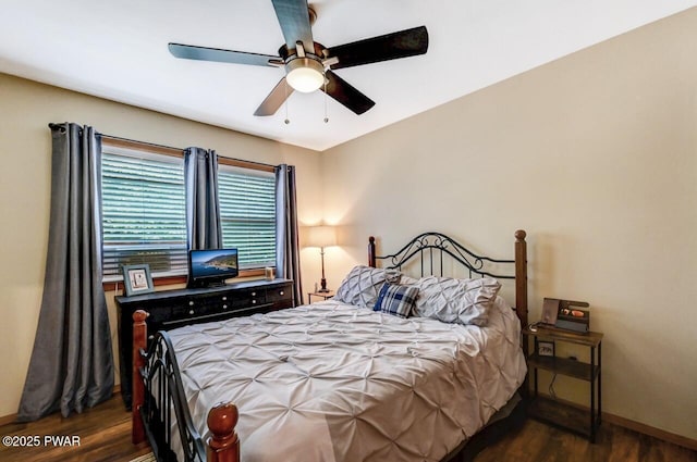 bedroom with dark hardwood / wood-style floors and ceiling fan