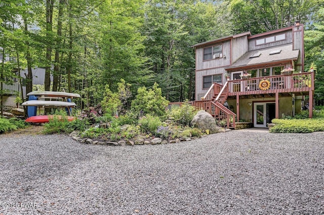 rear view of house with a wooden deck