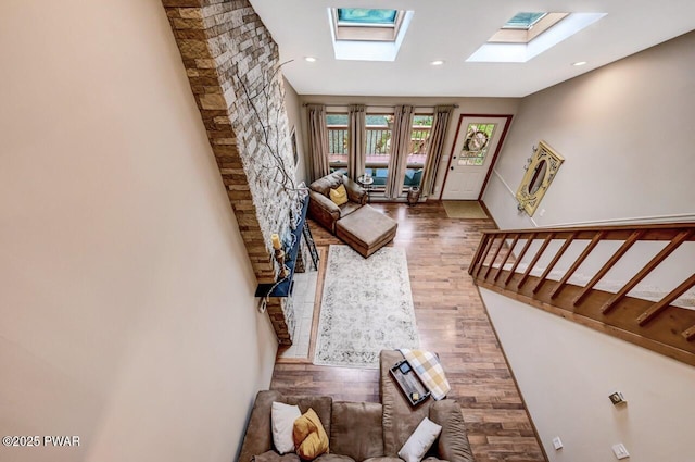 living room featuring dark wood-type flooring and a skylight