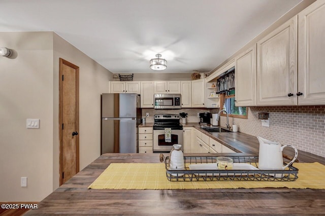 kitchen featuring sink, decorative backsplash, and stainless steel appliances