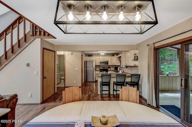 dining space featuring dark hardwood / wood-style flooring and sink