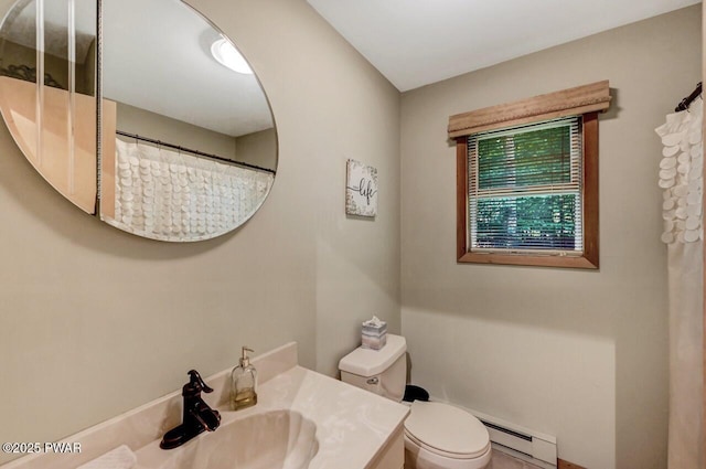 bathroom featuring vanity, a baseboard heating unit, and toilet