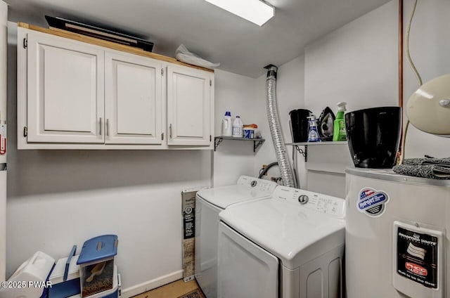 clothes washing area featuring cabinets, electric water heater, and washing machine and clothes dryer