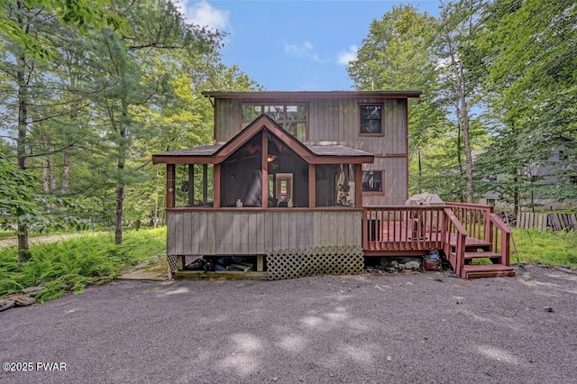 view of front of house featuring a sunroom and a deck