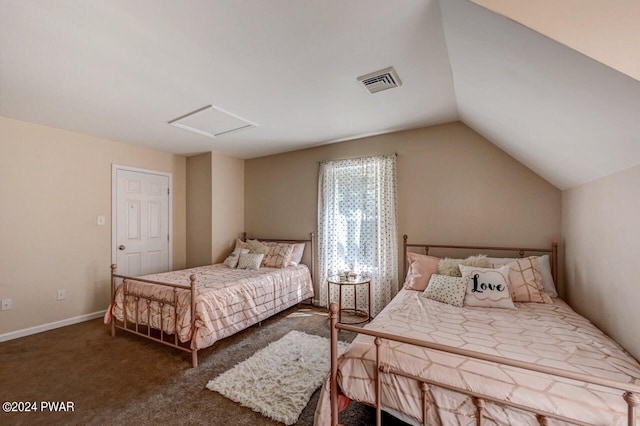 bedroom with vaulted ceiling and dark carpet