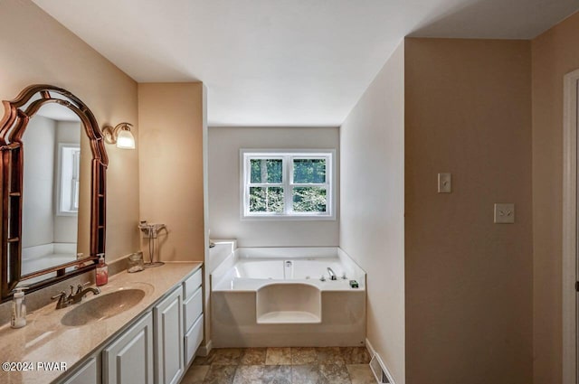 bathroom featuring vanity and a tub