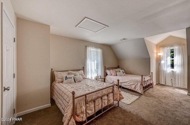 bedroom with dark carpet and lofted ceiling