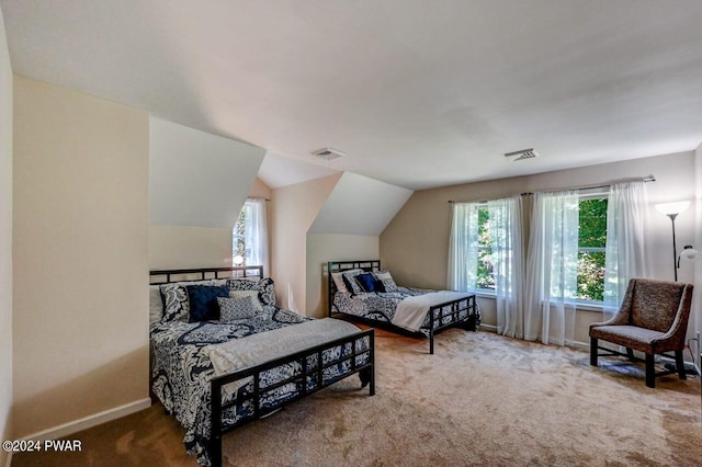 bedroom with carpet floors and vaulted ceiling