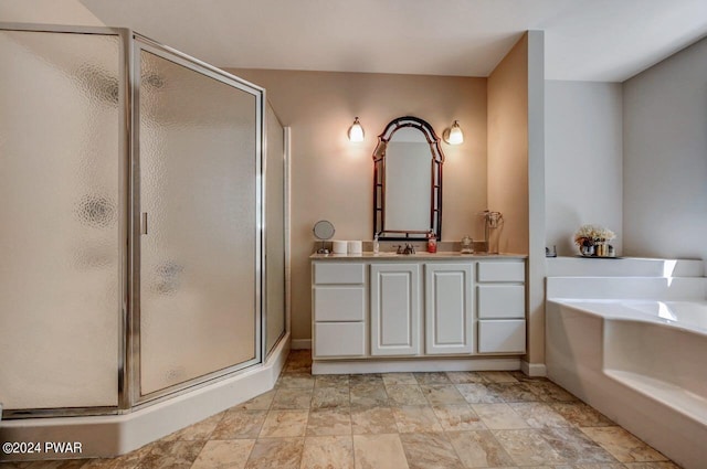 bathroom with vanity and independent shower and bath