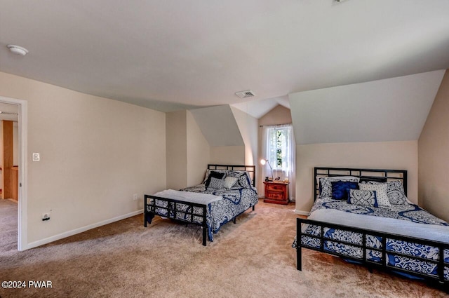 carpeted bedroom featuring lofted ceiling