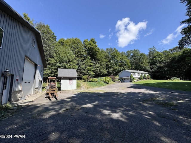 exterior space featuring a lawn and a storage shed