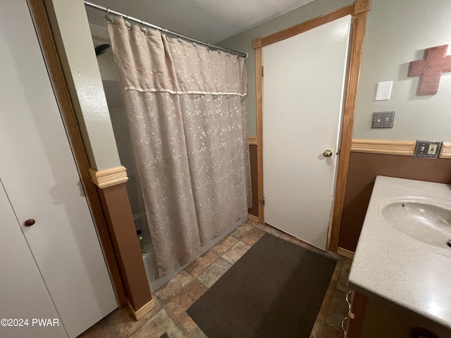 bathroom with vanity and shower / tub combo with curtain