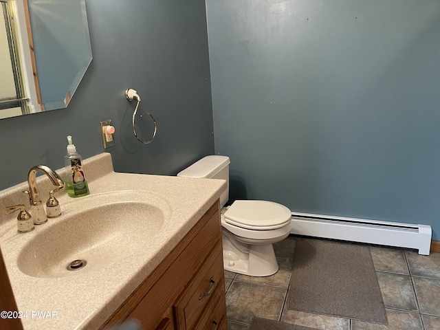 bathroom with baseboard heating, tile patterned floors, vanity, and toilet