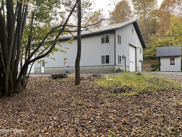 view of home's exterior featuring a garage and a storage shed