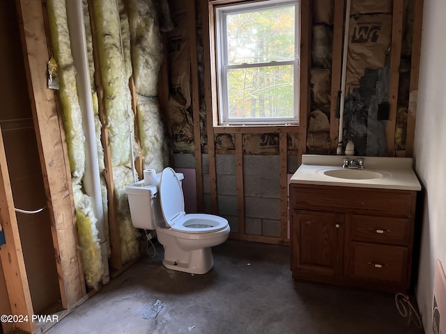 bathroom featuring toilet, sink, and concrete floors