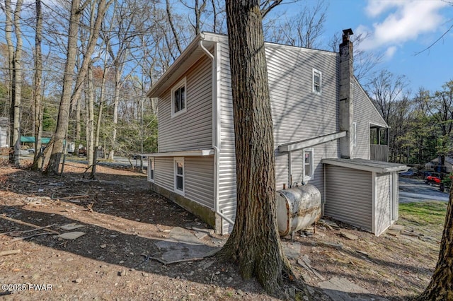 110 Maple Dr, Greentown, PA 18426 - view of property exterior with a chimney and heating fuel