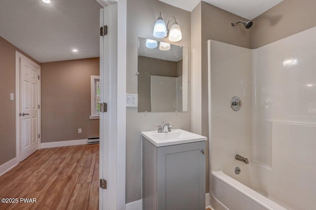 110 Maple Dr, Greentown, PA 18426 - full bath with wood finished floors, a baseboard radiator, bathing tub / shower combination, vanity, and baseboards