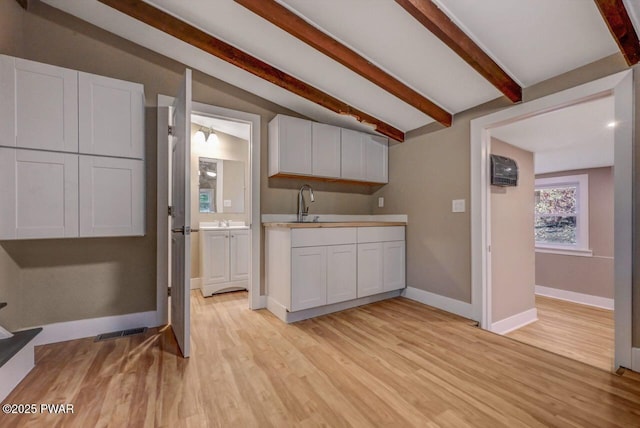 110 Maple Dr, Greentown, PA 18426 - kitchen with light wood-style floors, lofted ceiling with beams, visible vents, and baseboards