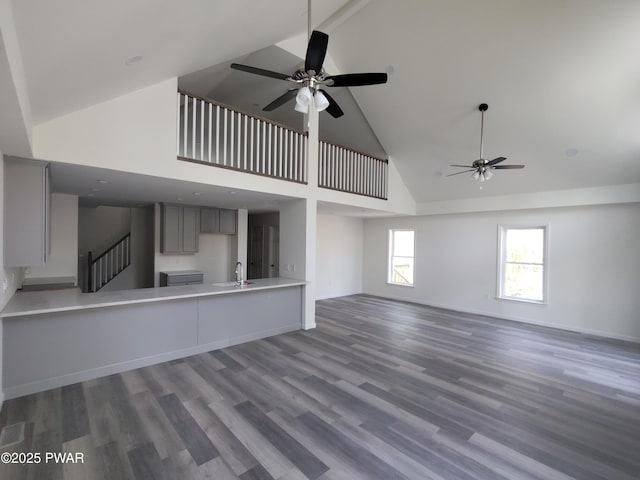 4409 Middleton Dr, Milford, PA 18337 - unfurnished living room featuring high vaulted ceiling, ceiling fan, a sink, and wood finished floors