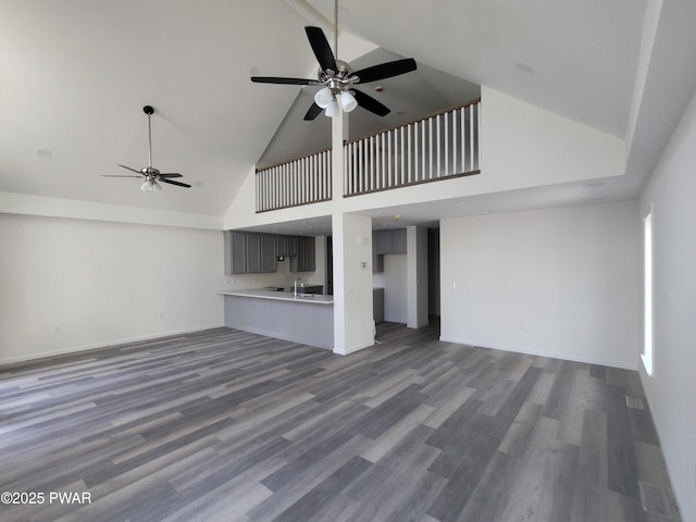 4409 Middleton Dr, Milford, PA 18337 - unfurnished living room with high vaulted ceiling, a ceiling fan, wood finished floors, and baseboards
