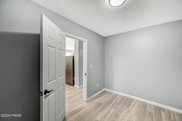 unfurnished room with light wood-type flooring