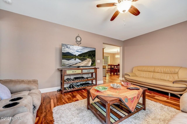 living room featuring wood-type flooring and ceiling fan