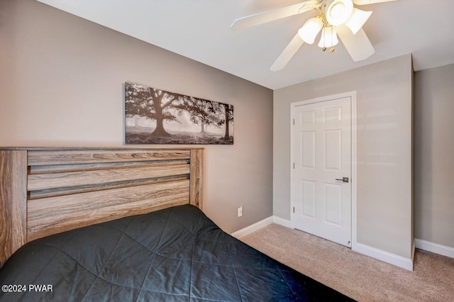 unfurnished bedroom featuring ceiling fan and carpet