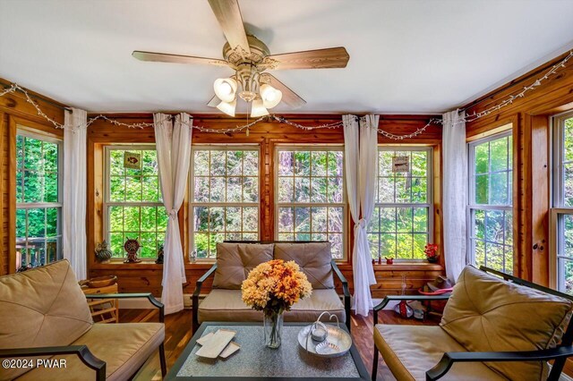 sunroom featuring a wealth of natural light and ceiling fan