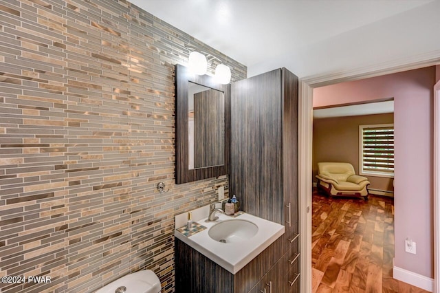 bathroom featuring hardwood / wood-style flooring, vanity, and a baseboard radiator