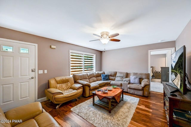 living room with ceiling fan and dark hardwood / wood-style flooring