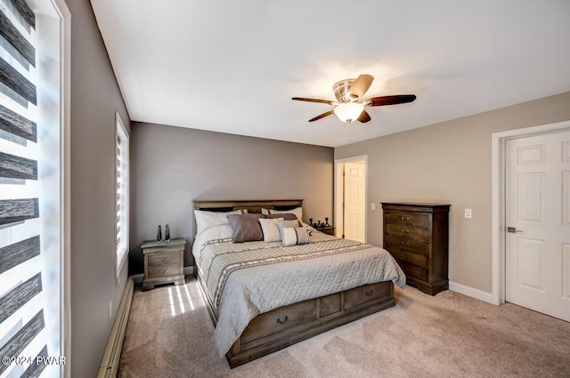 bedroom with ceiling fan, light colored carpet, and a baseboard heating unit