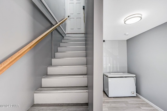 staircase with wood-type flooring